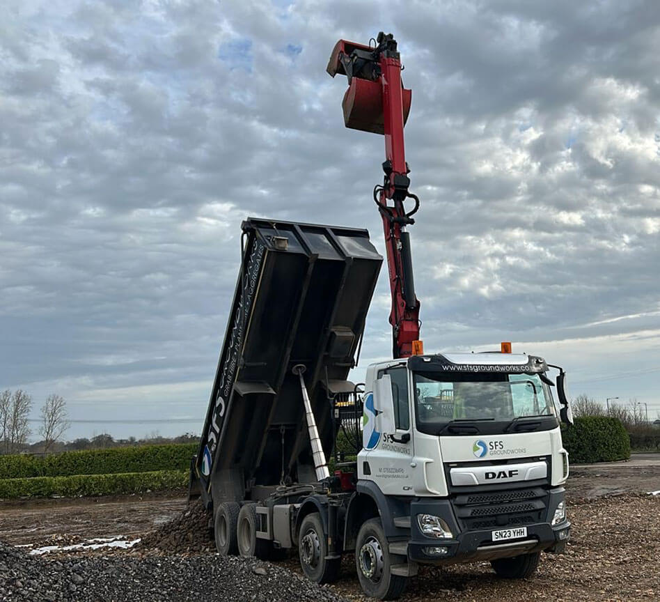 Tipper lorry delivering aggregates to a site
