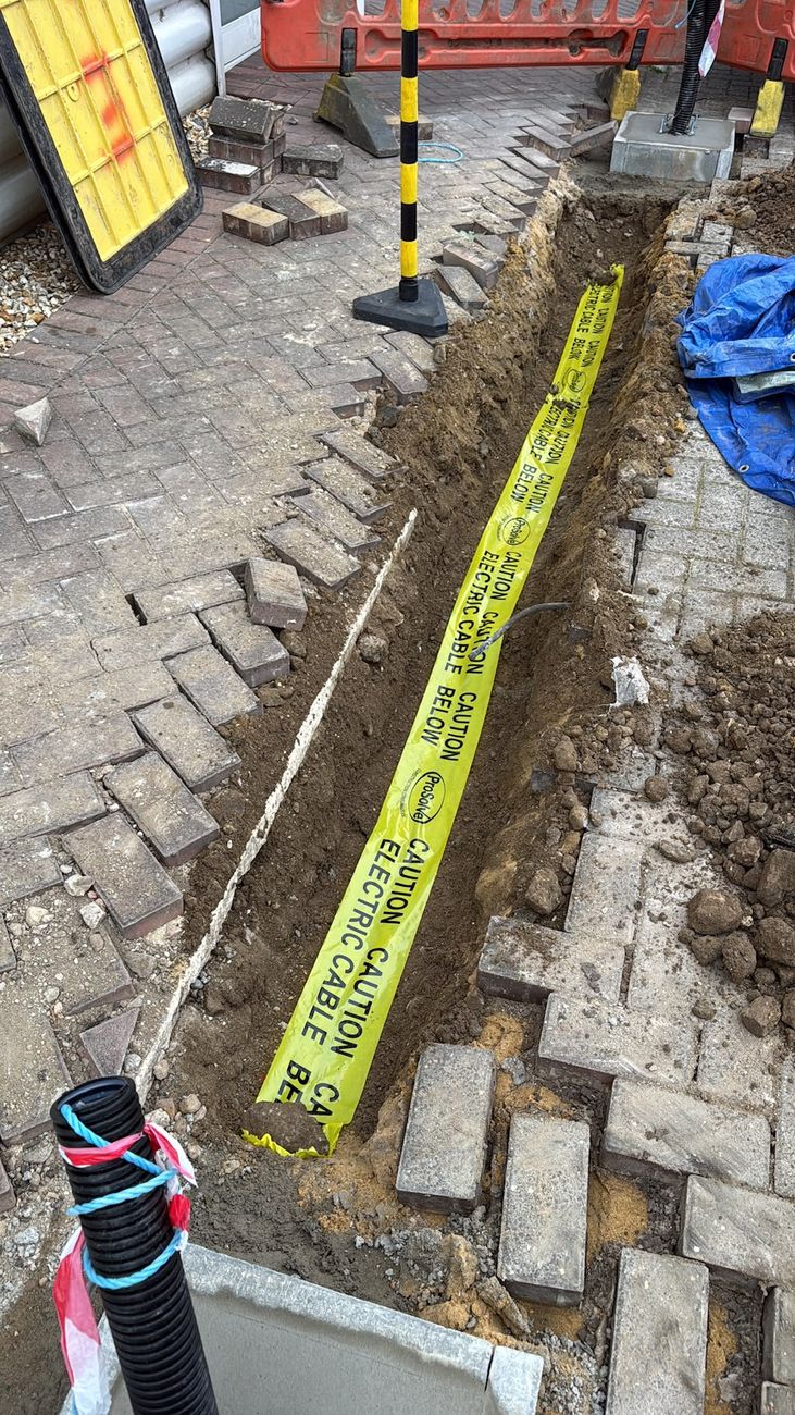 Trenching and ducting for EV charger cable routes with buried warning tape