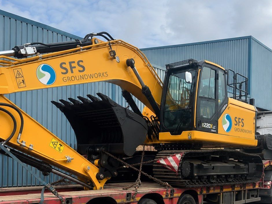 SFS Groundworks branded 22-tonne excavator loaded on a lowloader at the Tonbridge yard